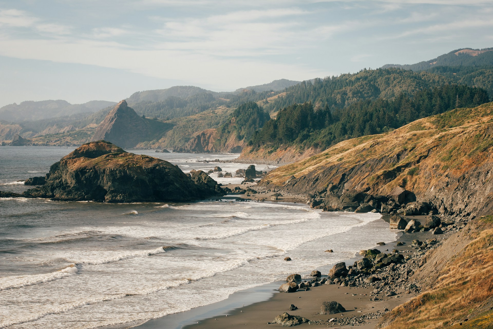Gold Beach Oregon coastline with sea stacks and forested cliffs